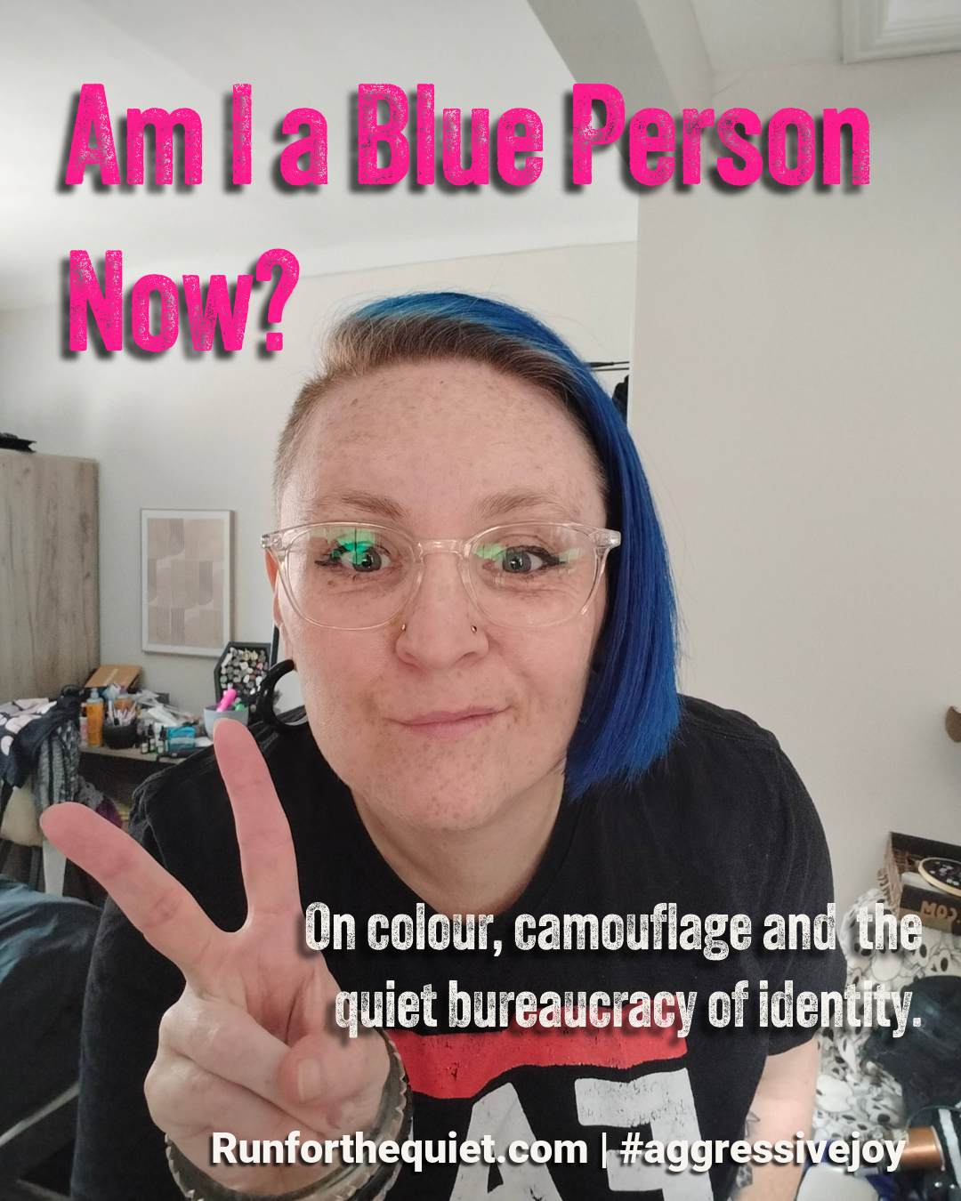 A smiling selfie of a person with vivid blue hair and clear frame glasses making a peace sign. Large pink text reads "Am I a Blue Person Now?" with the subtitle "On colour, camoflauge and the quiet bureaucracy of idenity." the image is to promote a personal essay on identity, masking and neurodivergent rule-making.